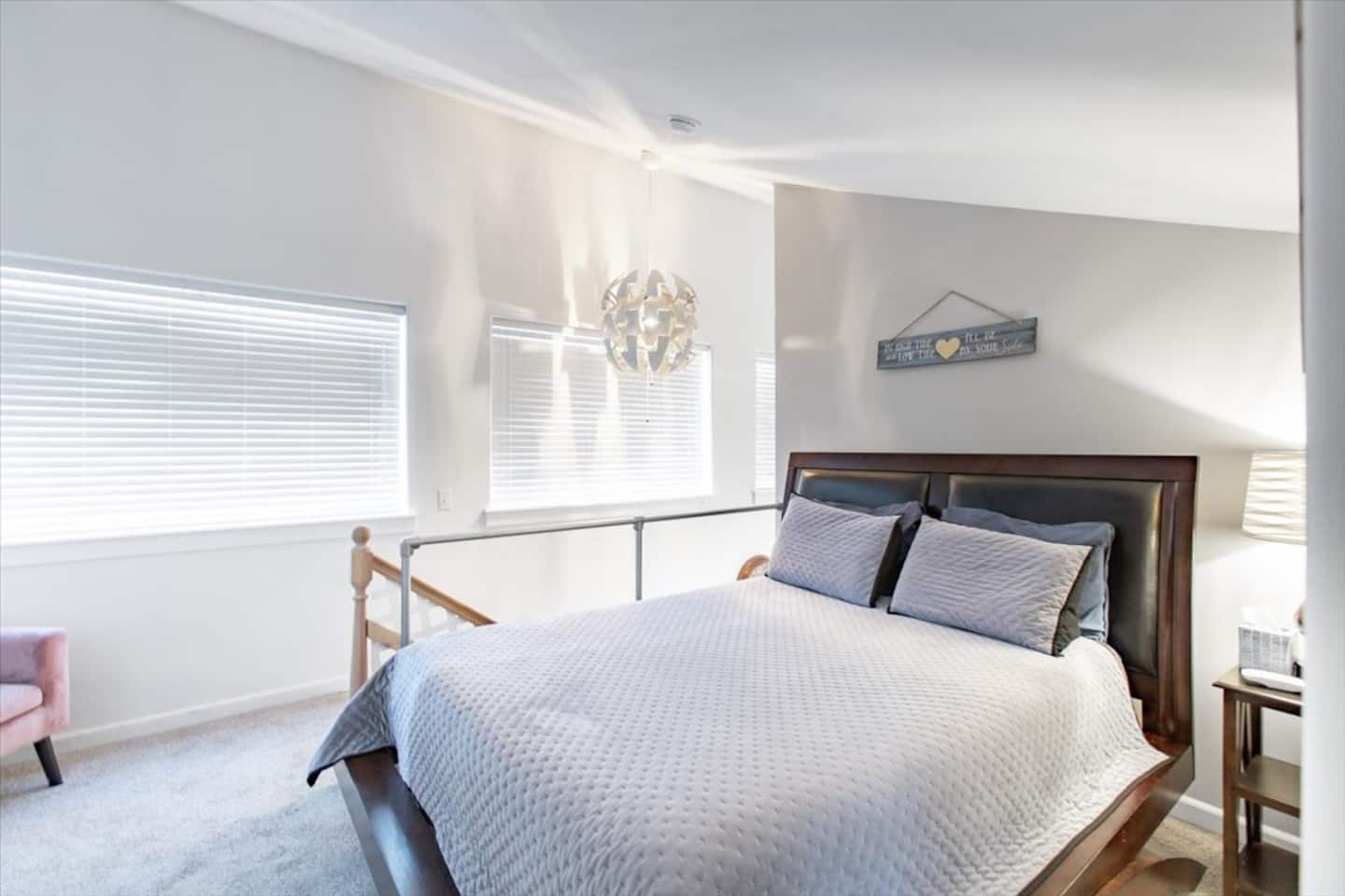 Calm upstairs bedroom with a queen bed