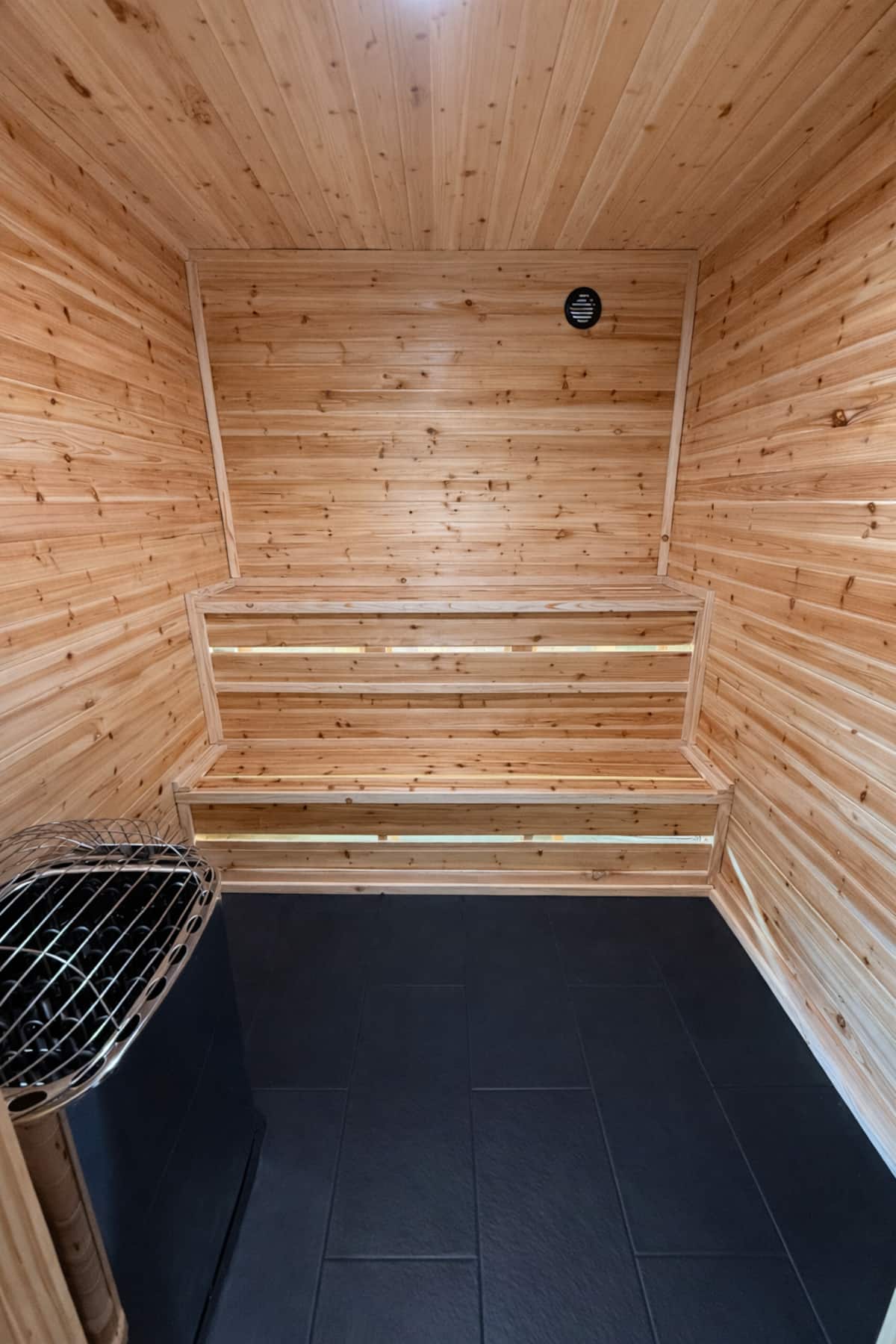 New cedar sauna with tiered benches and heated tile floor